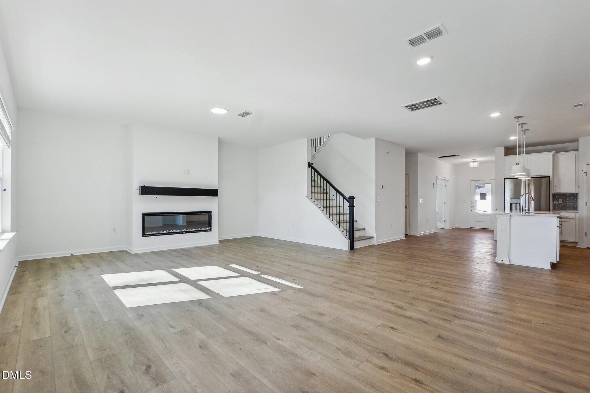 2209 Seraphic Way, Unit 402 Rolesville, NC 27571 - Photo 15 of 26 a view of kitchen and hall with wooden floor