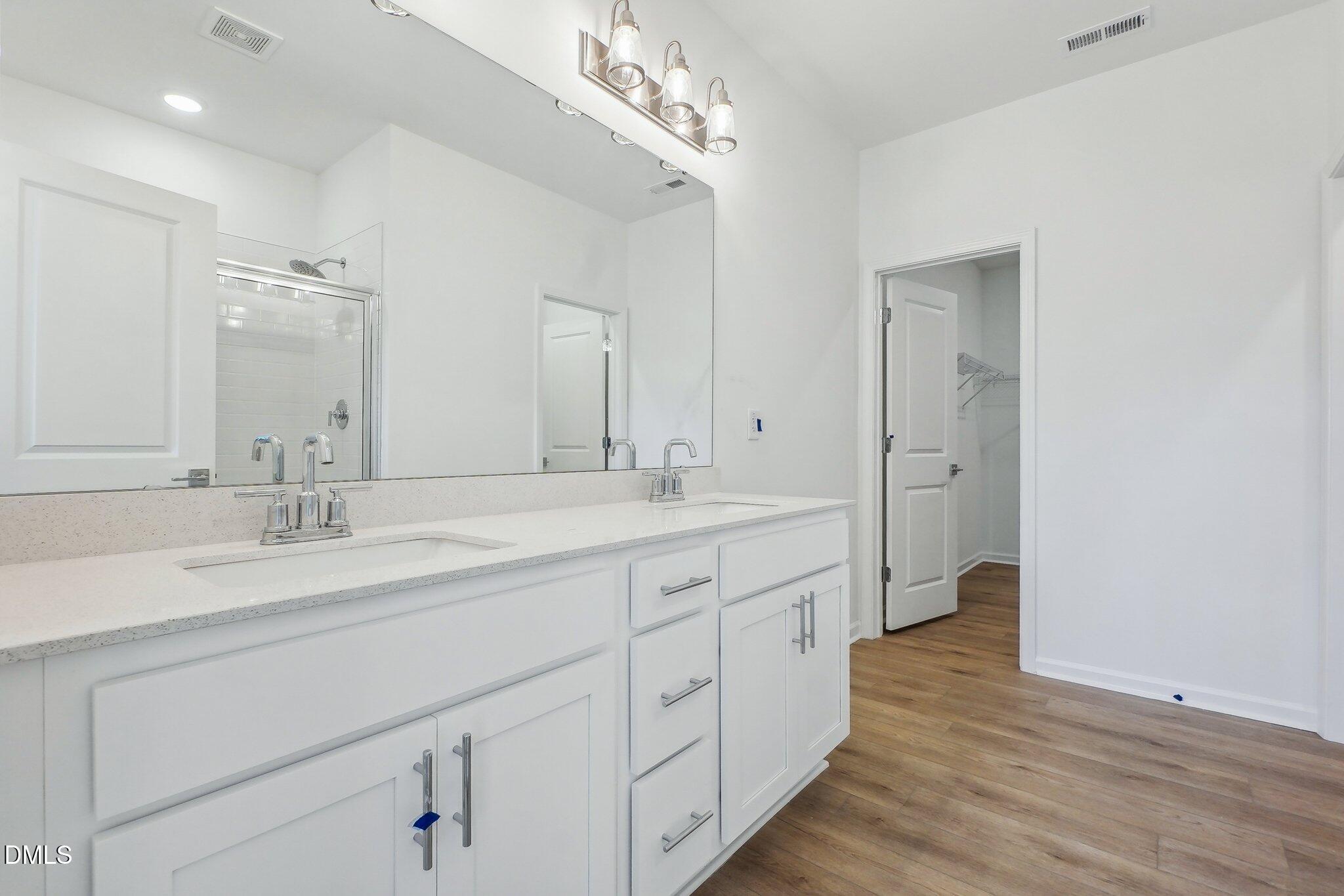 2209 Seraphic Way, Unit 402 Rolesville, NC 27571 - Photo 17 of 26 a spacious bathroom with a double vanity sink double and mirror