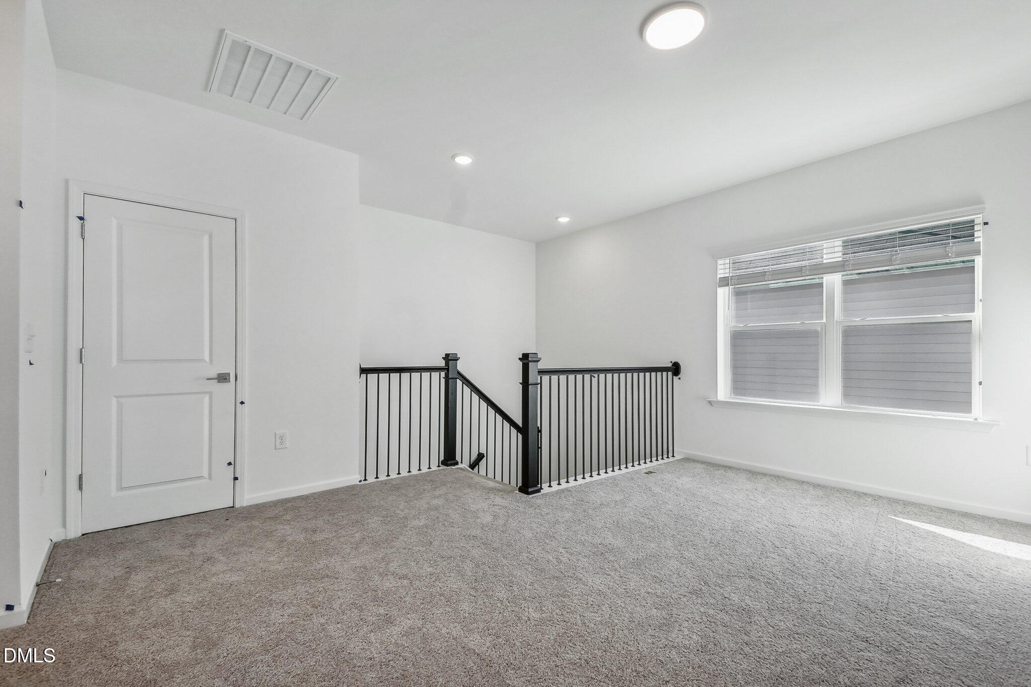2209 Seraphic Way, Unit 402 Rolesville, NC 27571 - Photo 19 of 26 a view of an empty room with a window