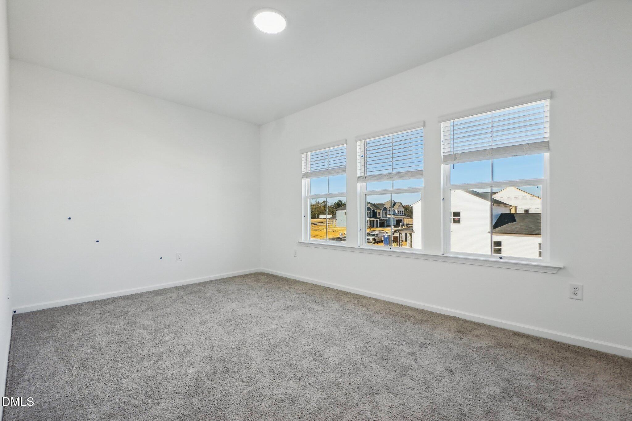2209 Seraphic Way, Unit 402 Rolesville, NC 27571 - Photo 22 of 26 an empty room with window and furniture