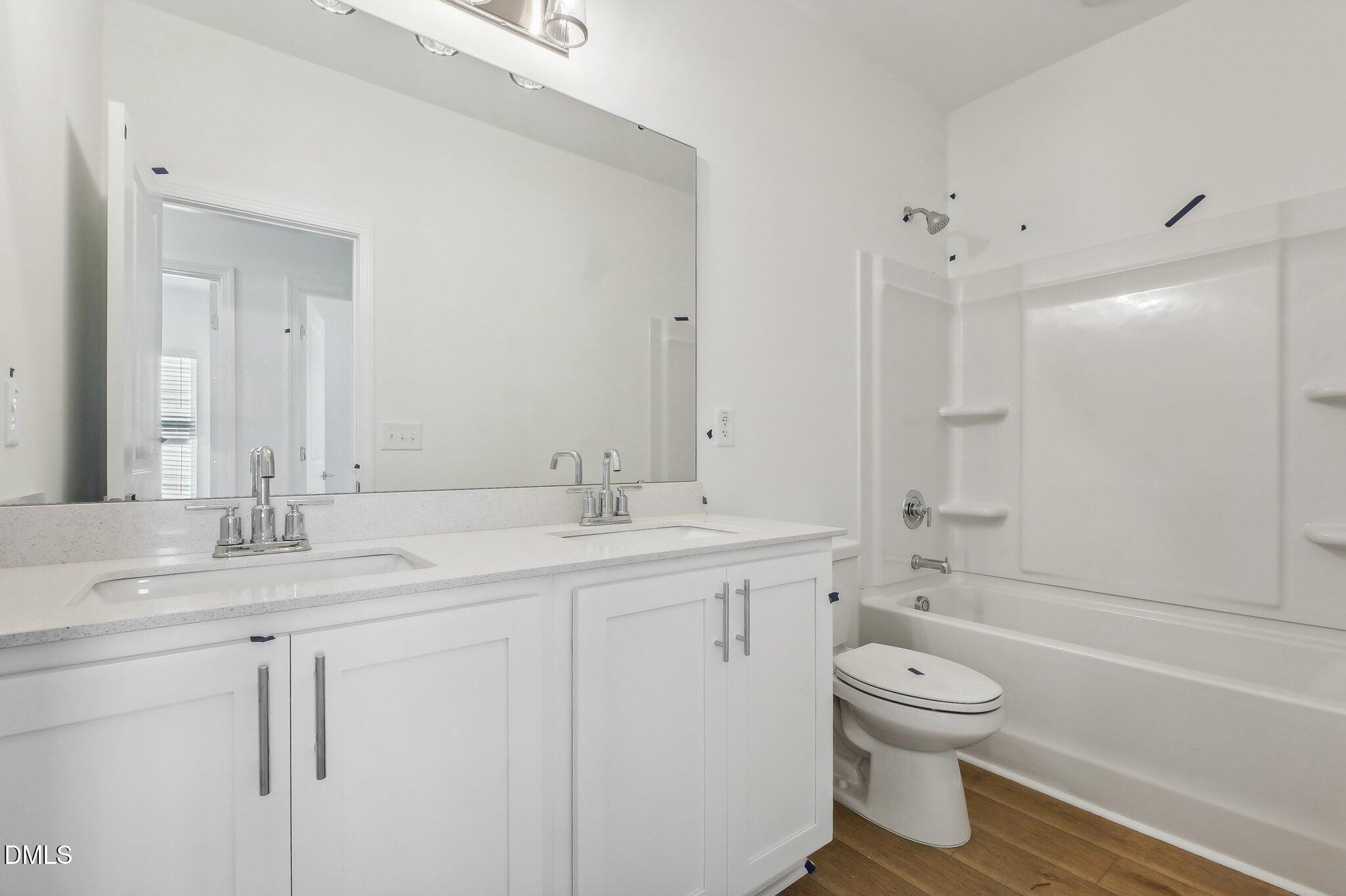 2209 Seraphic Way, Unit 402 Rolesville, NC 27571 - Photo 23 of 26 a bathroom with a sink toilet and shower