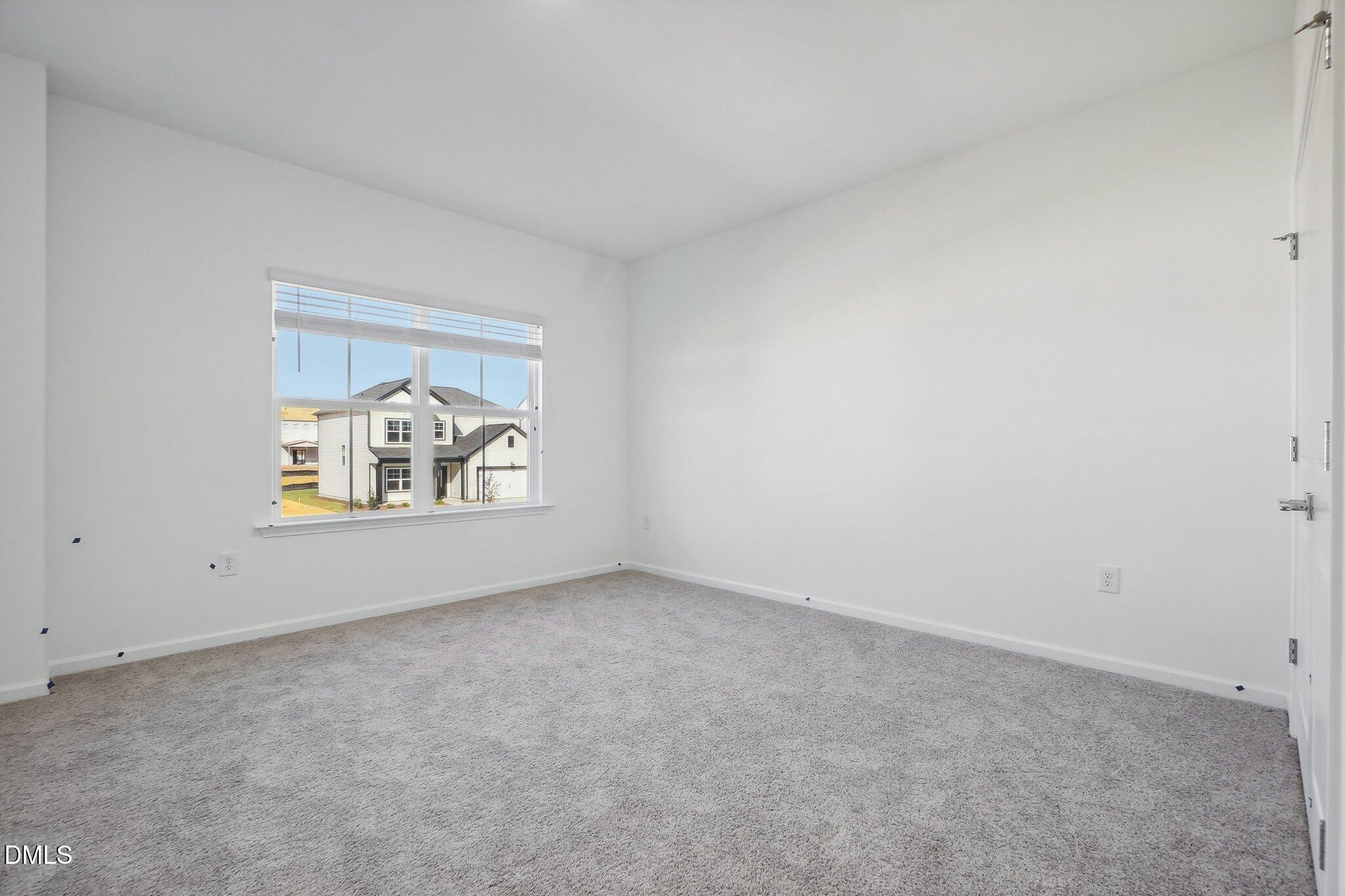 2209 Seraphic Way, Unit 402 Rolesville, NC 27571 - Photo 24 of 26 a view of an empty room and window