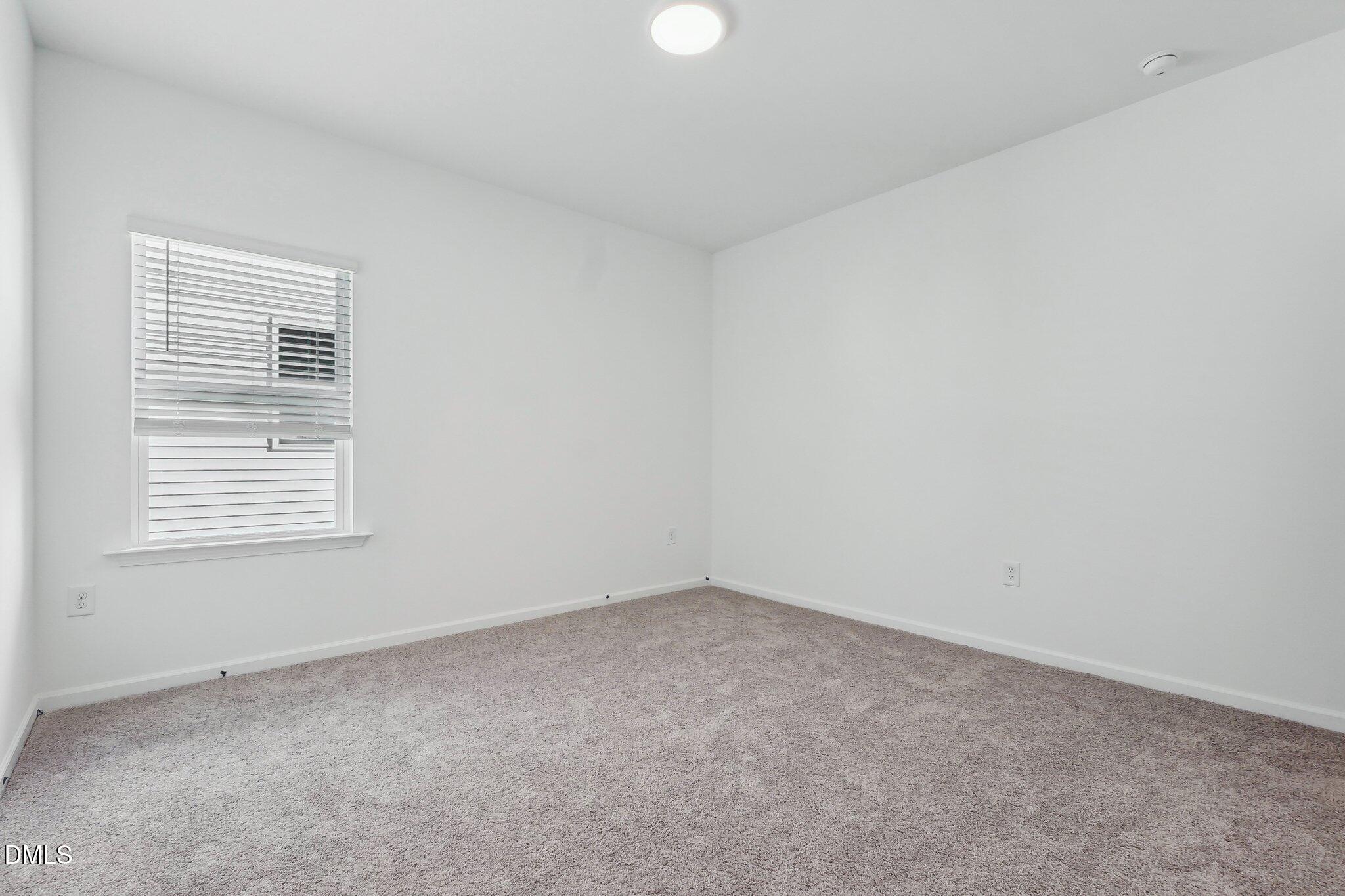 2209 Seraphic Way, Unit 402 Rolesville, NC 27571 - Photo 25 of 26 an empty room with a window