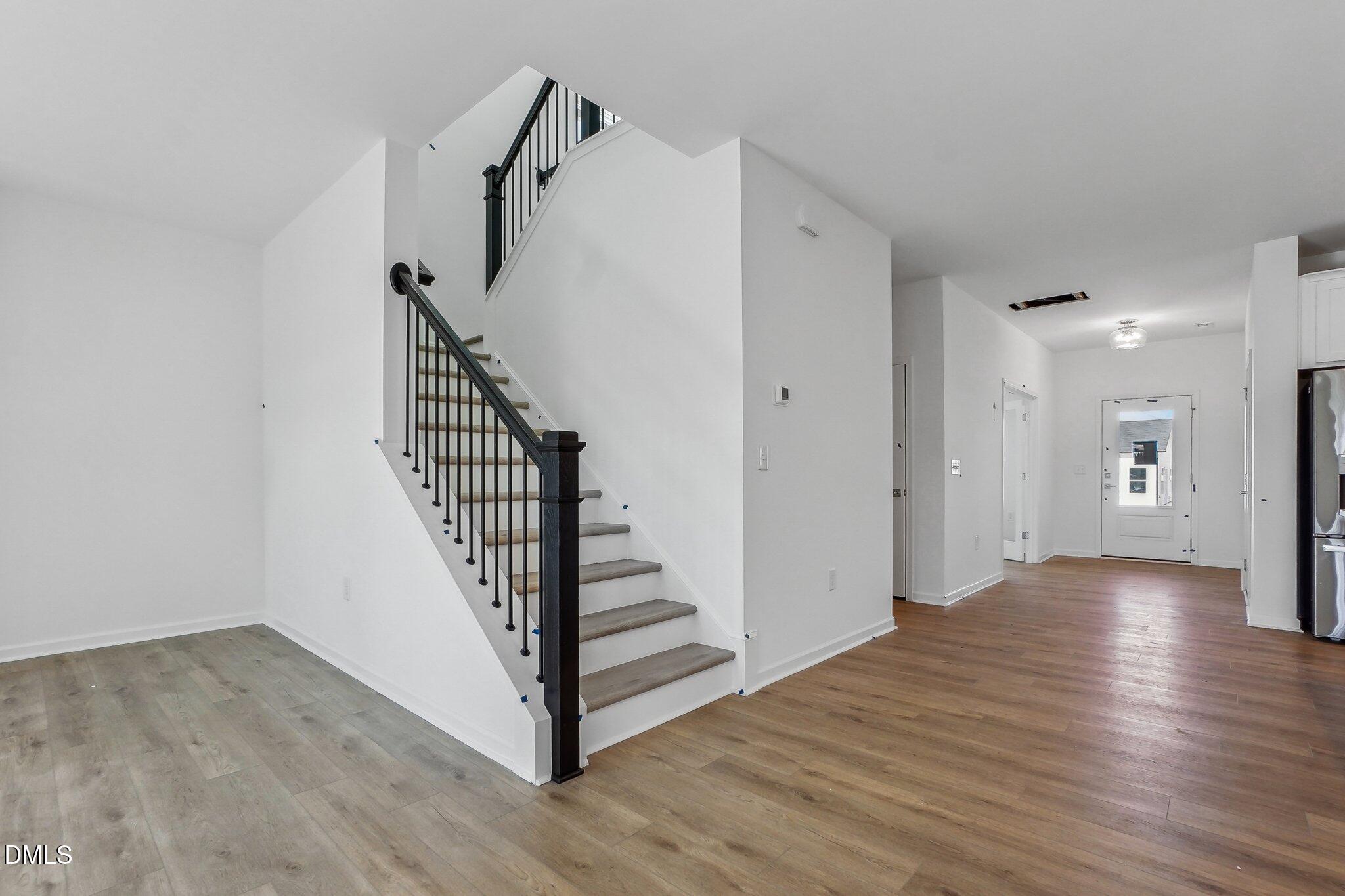 2209 Seraphic Way, Unit 402 Rolesville, NC 27571 - Photo 10 of 26 a view of a hallway view with wooden floor and staircase