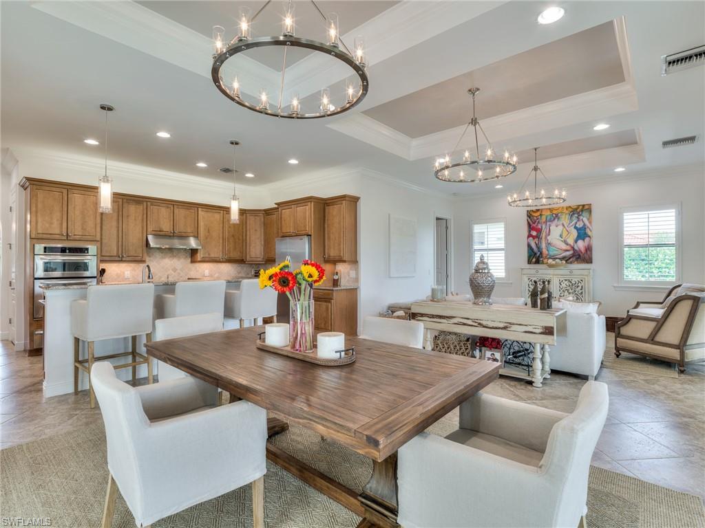 14468 Marsala Way Naples, FL 34109 - Photo 13 of 41 a living room with kitchen island furniture and a chandelier