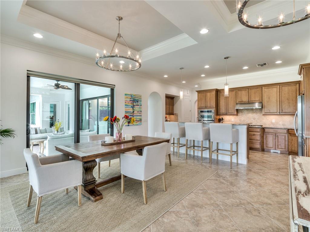 14468 Marsala Way Naples, FL 34109 - Photo 14 of 41 a view of a dining room with furniture a kitchen and chandelier