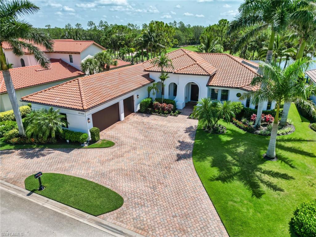 14468 Marsala Way Naples, FL 34109 - Photo 2 of 41 a aerial view of a white house sitting next to a yard with potted plants