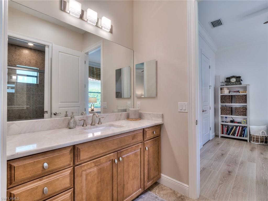 14468 Marsala Way Naples, FL 34109 - Photo 30 of 41 a bathroom with a sink a vanity and a mirror