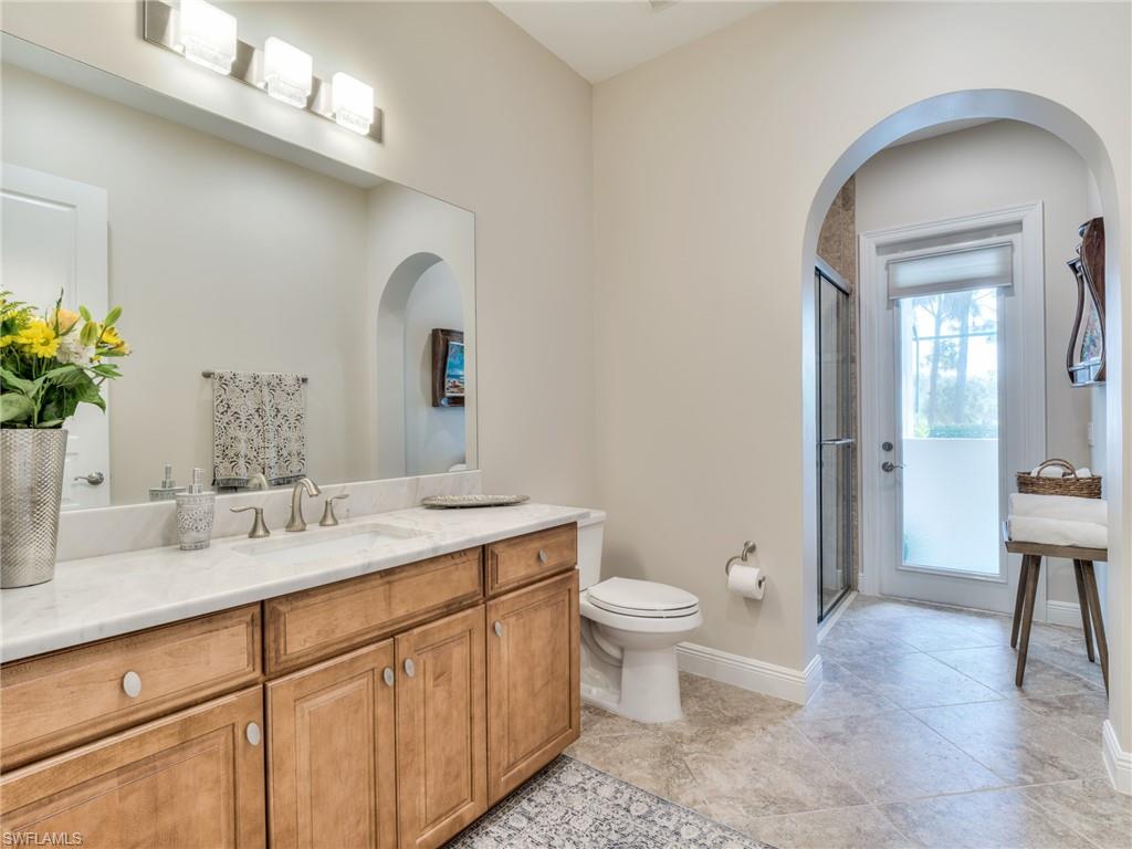 14468 Marsala Way Naples, FL 34109 - Photo 39 of 41 a spacious bathroom with a toilet sink and mirror