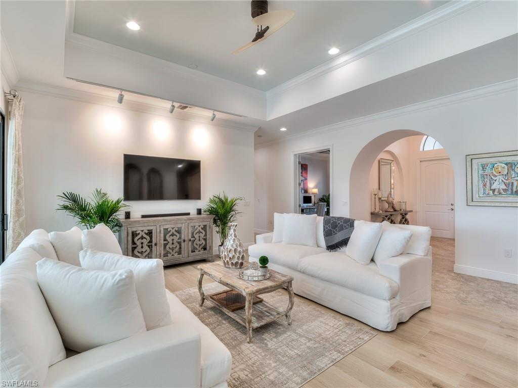 14468 Marsala Way Naples, FL 34109 - Photo 7 of 41 a living room with furniture and a flat screen tv