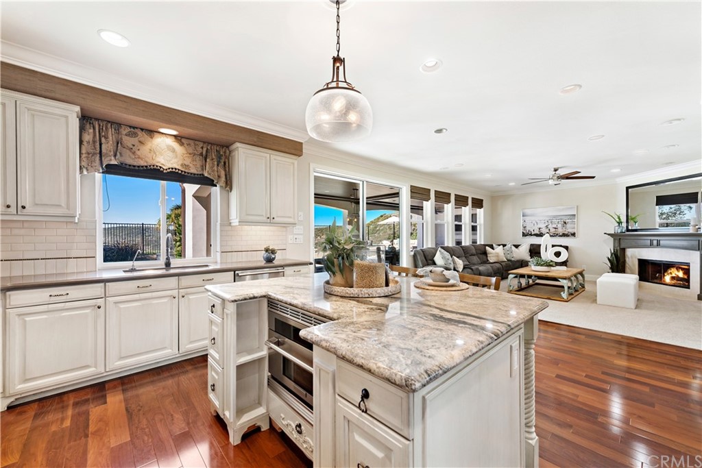 37 Oak View Drive Aliso Viejo, CA 92656 - Photo 14 of 46 a kitchen with sink stove and white cabinets with wooden floor