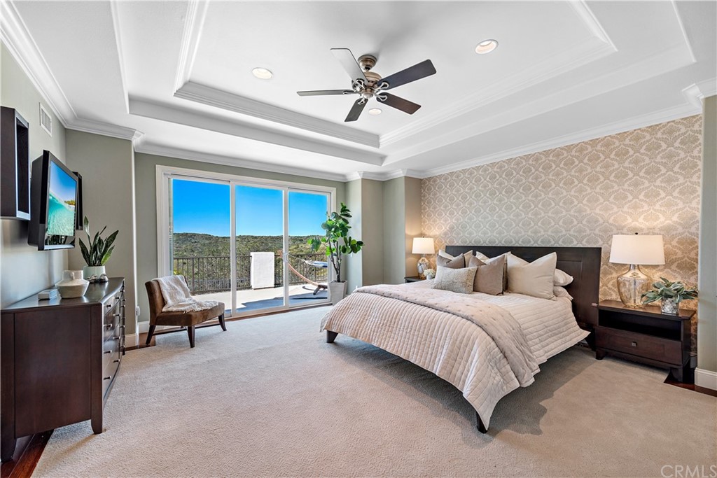 37 Oak View Drive Aliso Viejo, CA 92656 - Photo 24 of 46 a bedroom with a bed a couch and a chandelier