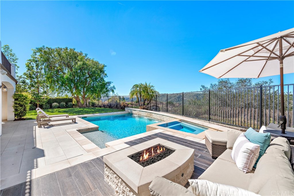 37 Oak View Drive Aliso Viejo, CA 92656 - Photo 38 of 46 a view of a patio with couches and table and chairs under an umbrella