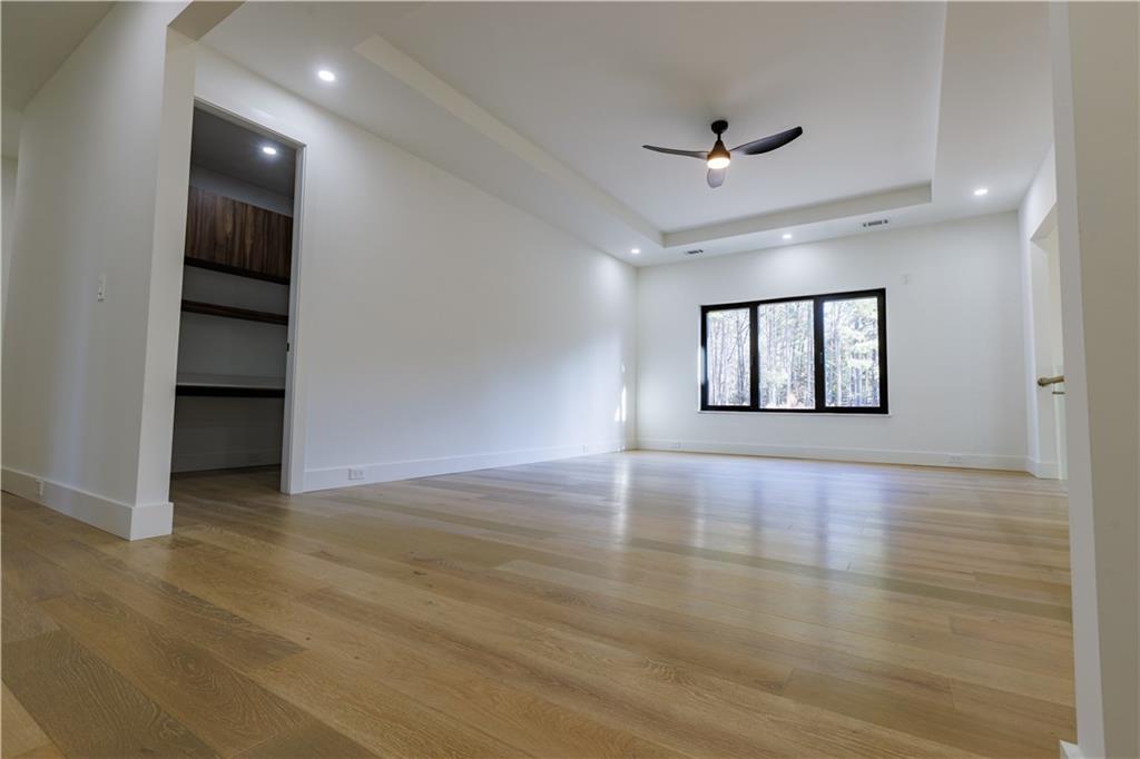 4805 Moore Road Suwanee, GA 30024 - Photo 11 of 119 an empty room with wooden floor and windows