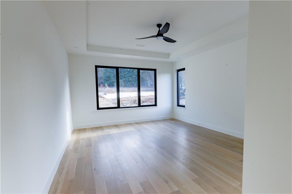 4805 Moore Road Suwanee, GA 30024 - Photo 111 of 119 a view of an empty room with a window and wooden floor