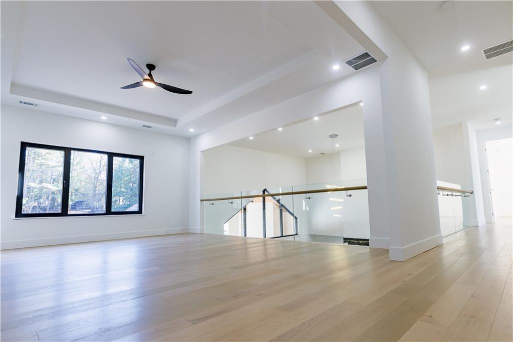 4805 Moore Road Suwanee, GA 30024 - Photo 12 of 119 a view of an empty room with wooden floor and a window