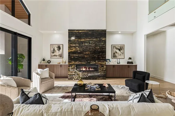 a kitchen with stainless steel appliances granite countertop a table chairs stove and cabinets