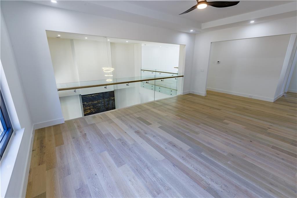 4805 Moore Road Suwanee, GA 30024 - Photo 19 of 119 a view of an empty room with wooden floor