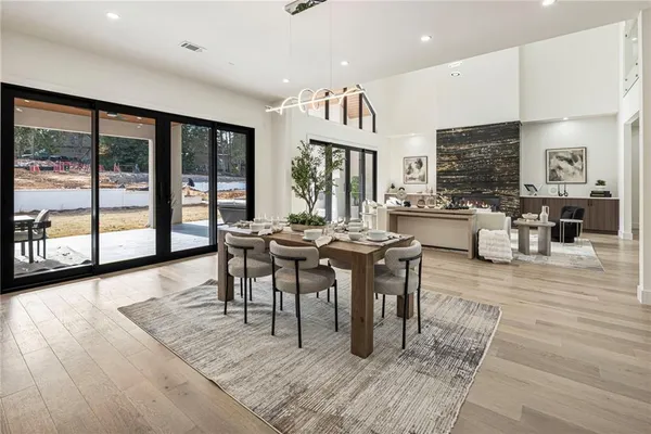 a bathroom with a tub a sink and a large mirror