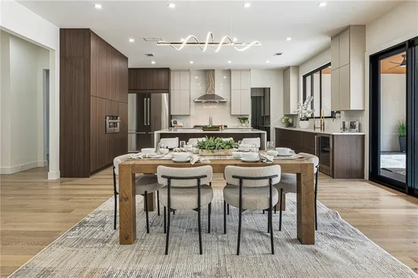 a view of a hallway with wooden floor and a potted plant