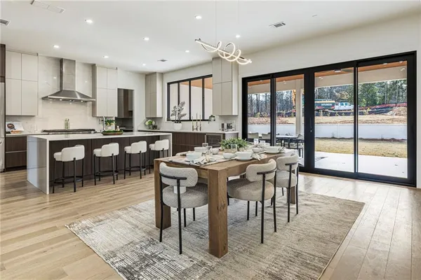 a view of a living room with furniture and wooden floor