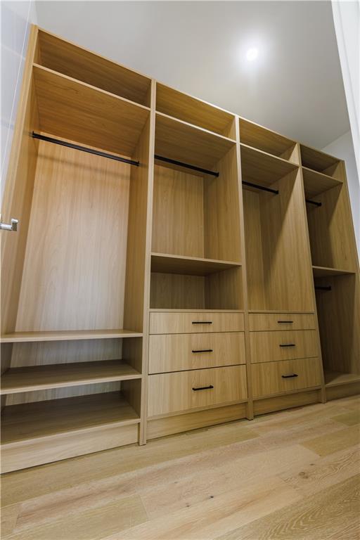 4805 Moore Road Suwanee, GA 30024 - Photo 26 of 119 a view of walk in closet with empty racks