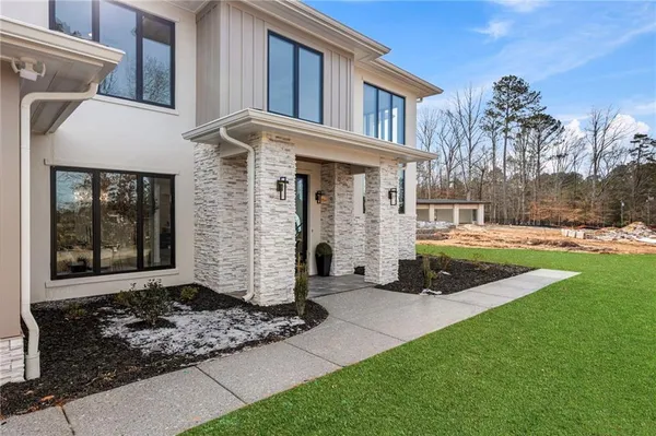 a front view of a house with garden