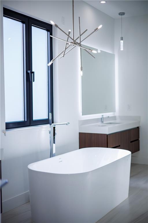 4805 Moore Road Suwanee, GA 30024 - Photo 33 of 119 a bathroom with a bathtub and a mirror