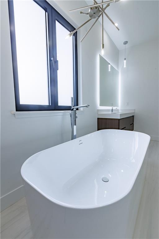 4805 Moore Road Suwanee, GA 30024 - Photo 45 of 119 a white bath tub sitting in a bathroom