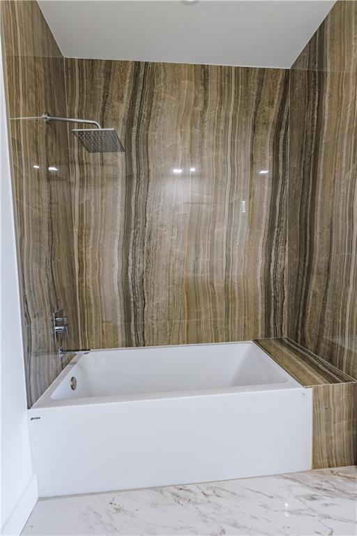 4805 Moore Road Suwanee, GA 30024 - Photo 72 of 119 a bathroom with a bathtub and shower