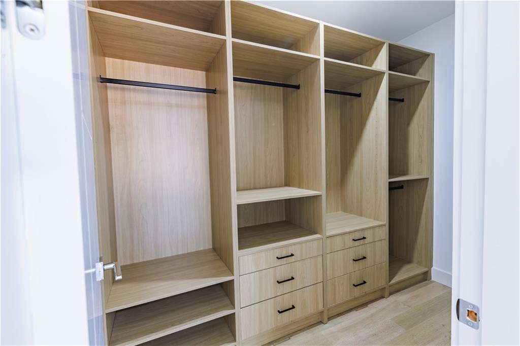 4805 Moore Road Suwanee, GA 30024 - Photo 81 of 119 a view of walk in closet with empty racks