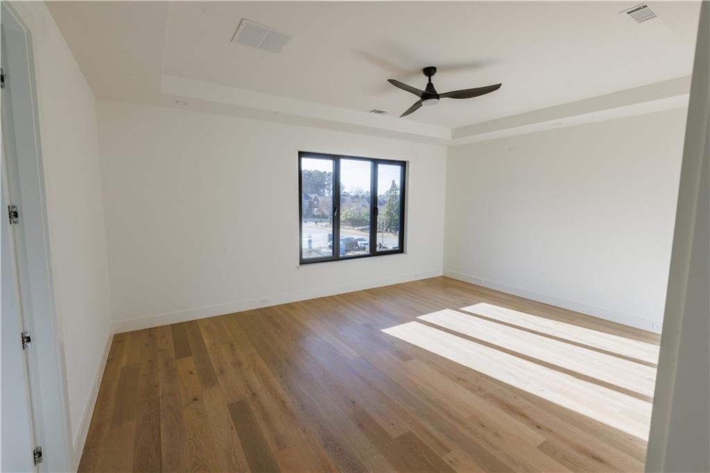 4805 Moore Road Suwanee, GA 30024 - Photo 84 of 119 wooden floor in an empty room with a window