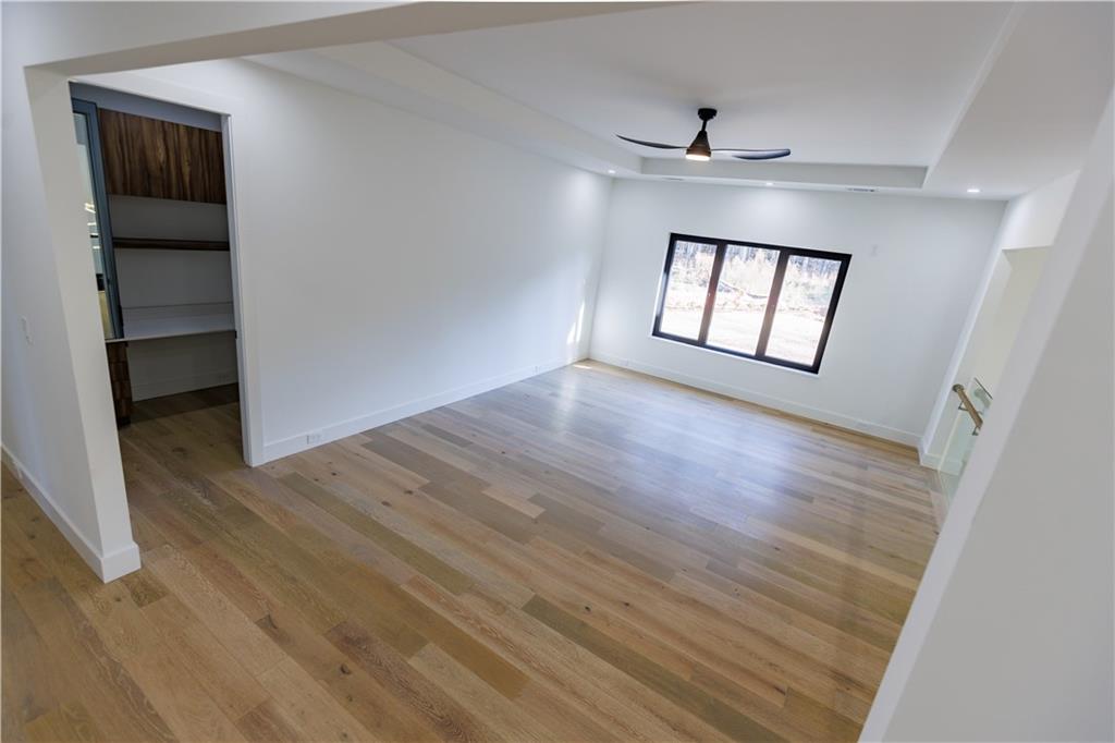 4805 Moore Road Suwanee, GA 30024 - Photo 9 of 119 wooden floor in an empty room with a window