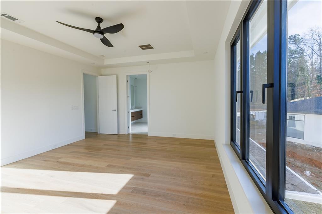4805 Moore Road Suwanee, GA 30024 - Photo 91 of 119 a view of empty room with wooden floor and fan