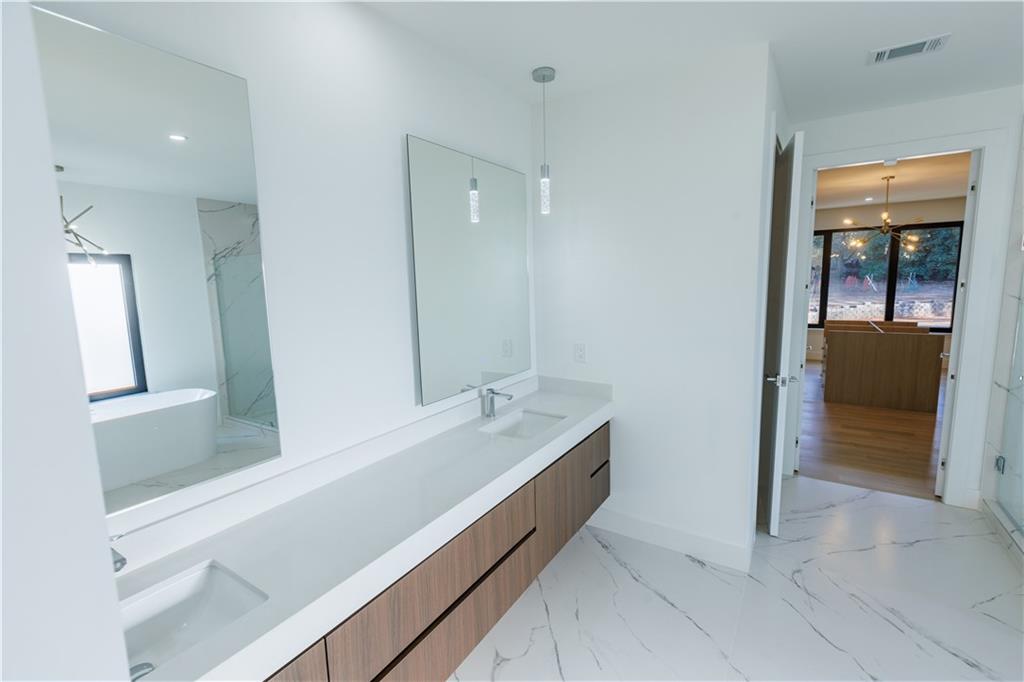 4805 Moore Road Suwanee, GA 30024 - Photo 96 of 119 a bathroom with a bathtub and a sink