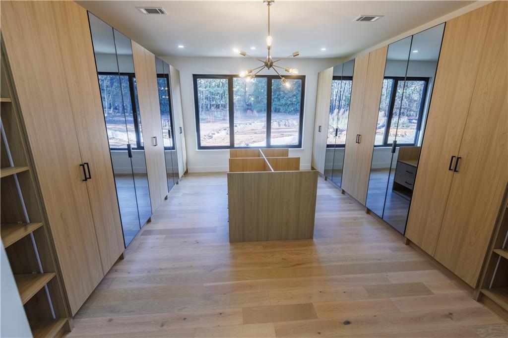 4805 Moore Road Suwanee, GA 30024 - Photo 100 of 119 a view of a hallway with wooden floor and windows
