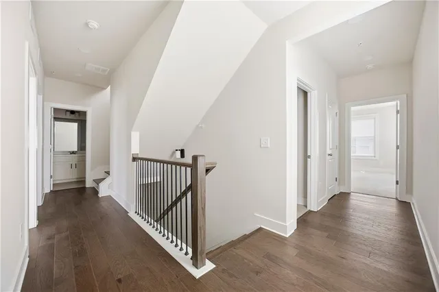 a view of a hallway with wooden floor