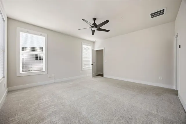 a view of a livingroom with a ceiling fan and window