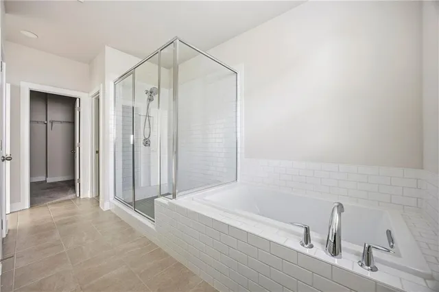a bathroom with a bathtub and a shower