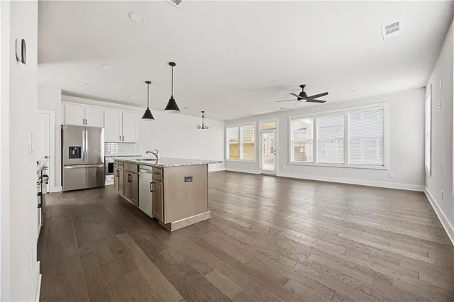 a view of a kitchen with a sink wooden floor and a kitchen