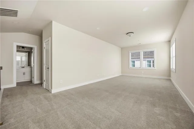 a view of a big room with windows and bathroom