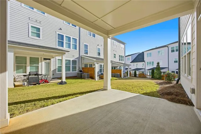 a view of a house with backyard and porch