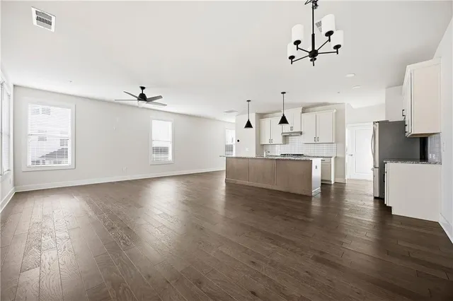 a view of a kitchen with a sink wooden cabinets and a window