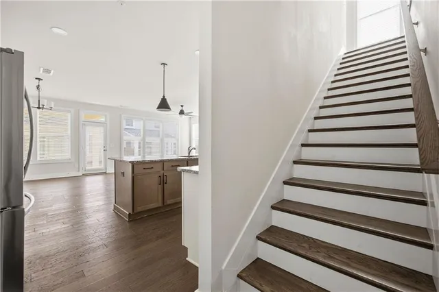 a view of a kitchen with wooden floor and stairs