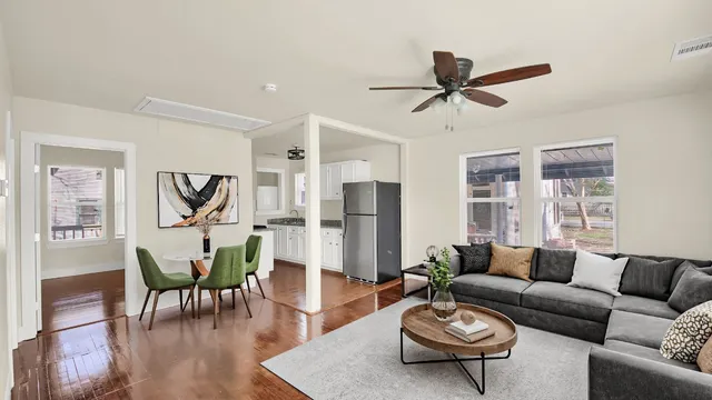 a living room with furniture a rug and a chandelier