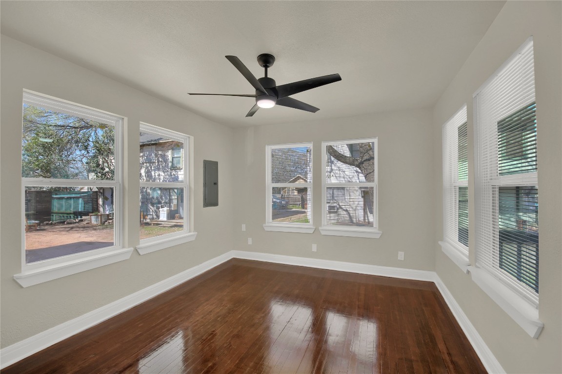 4010 Speedway, Unit A Austin, TX 78751 - Photo 3 of 10 a view of an empty room with wooden floor and a window