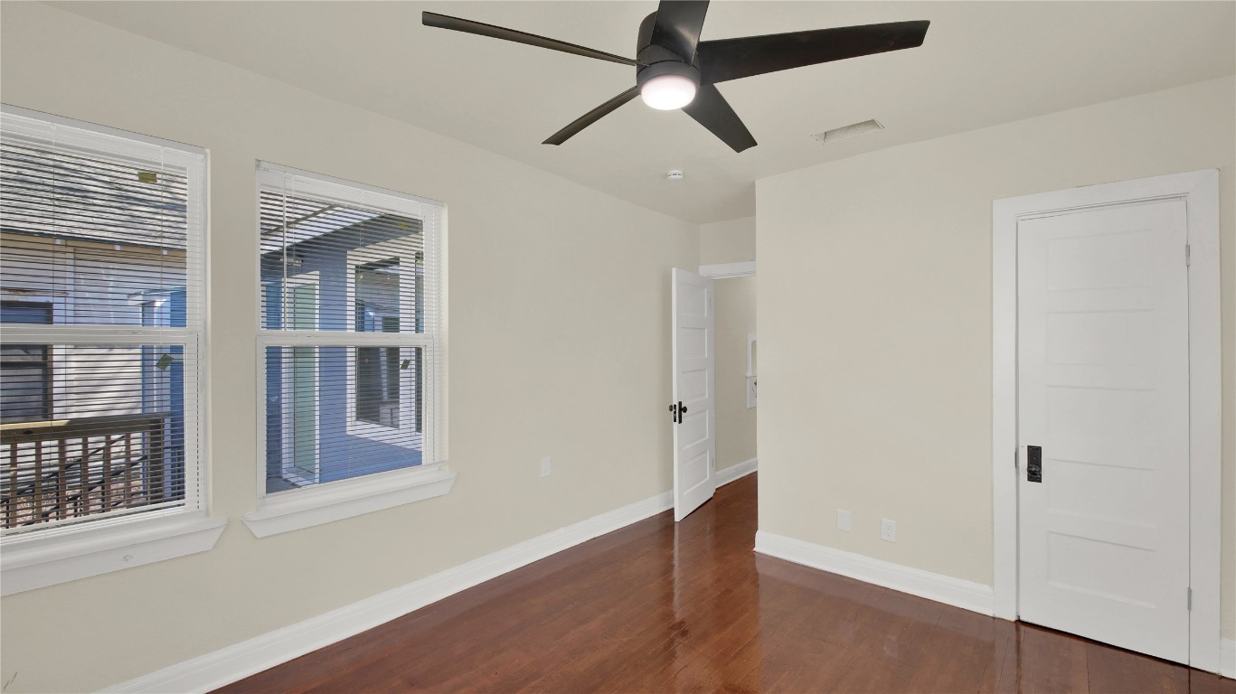 4010 Speedway, Unit A Austin, TX 78751 - Photo 5 of 10 a view of an empty room with wooden floor and a window