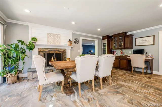 a living room with furniture a fireplace and a potted plant