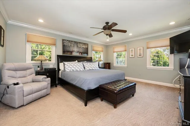 a bedroom with a bed a couch and a window