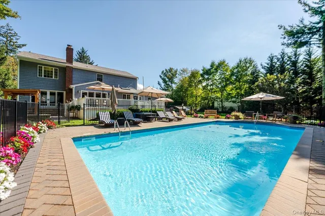 a view of swimming pool with seating area and furniture